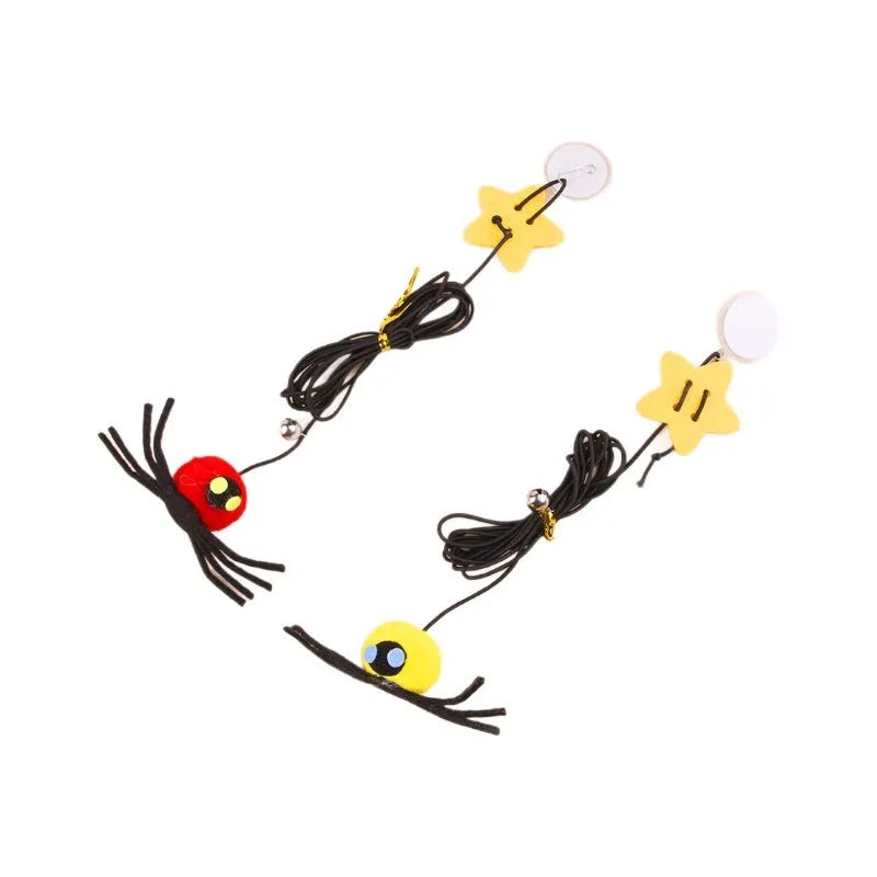 Cat hanging door toy with elastic rope, feather, bell and spider attachment on a white door.