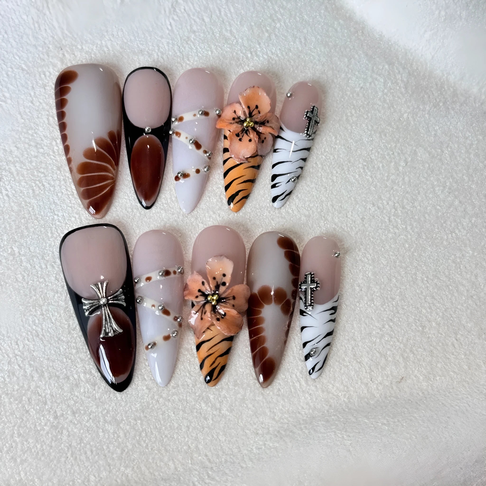 Handmade gel nail stickers with leopard, cross, and flower prints in a pack of ten.