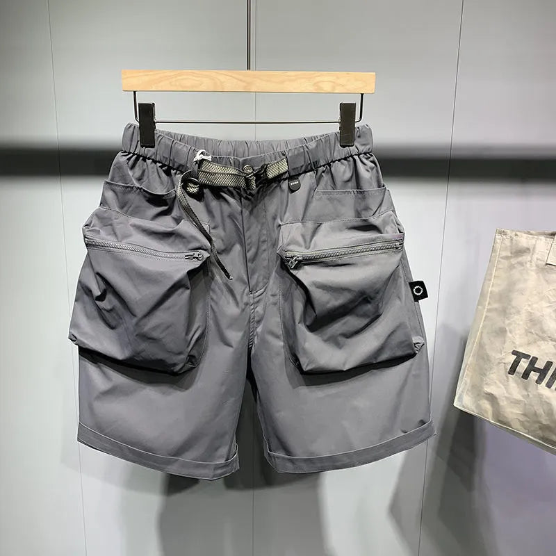 Men's loose fit black casual shorts with large side pockets and an elasticated waistband.