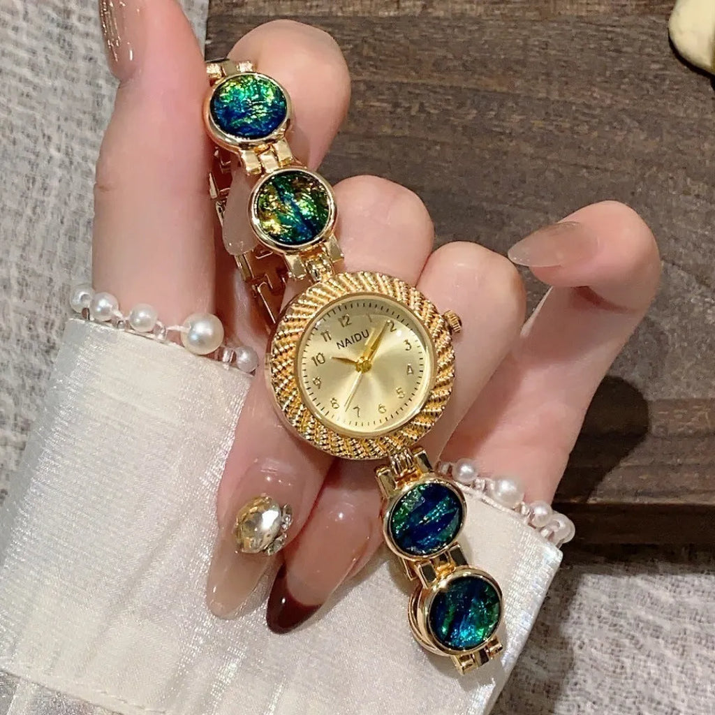 Women's quartz watch with 25mm round dial in one of six colours including dark green and purple