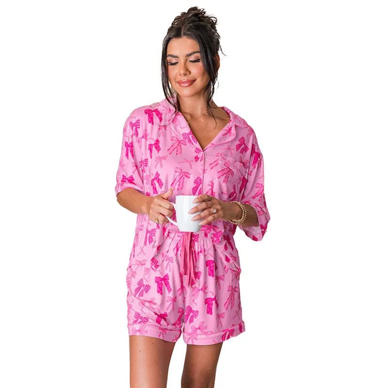 Pink bow print women's polyester pajama set showing top and pants for sleepwear