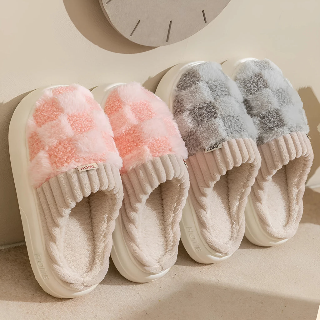 Plaid patterned women's indoor slippers in various colours with a soft sole and plush interior.