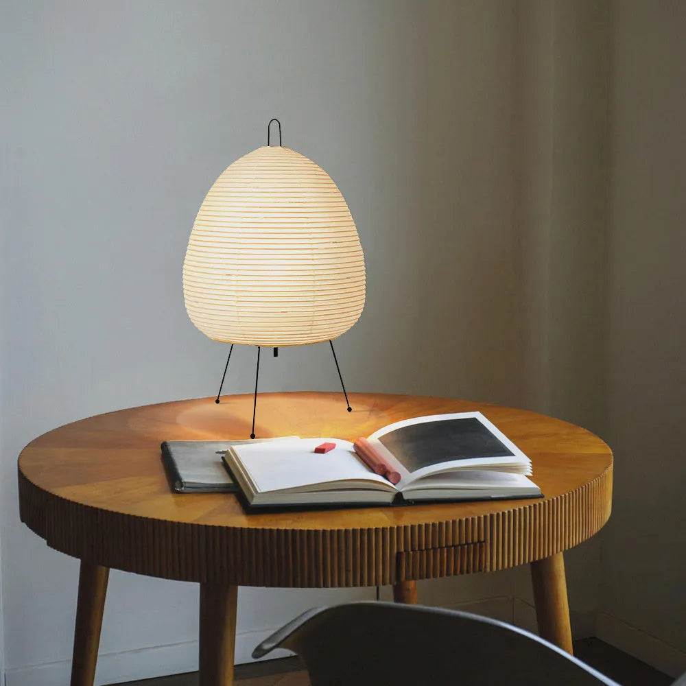 Japanese style table lamp with rice paper shade and aluminium base showing warm glow