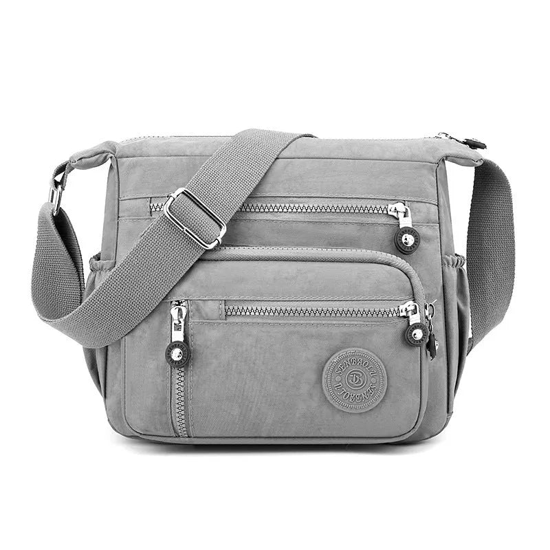 Gray nylon shoulder messenger bag with square vertical design and single strap