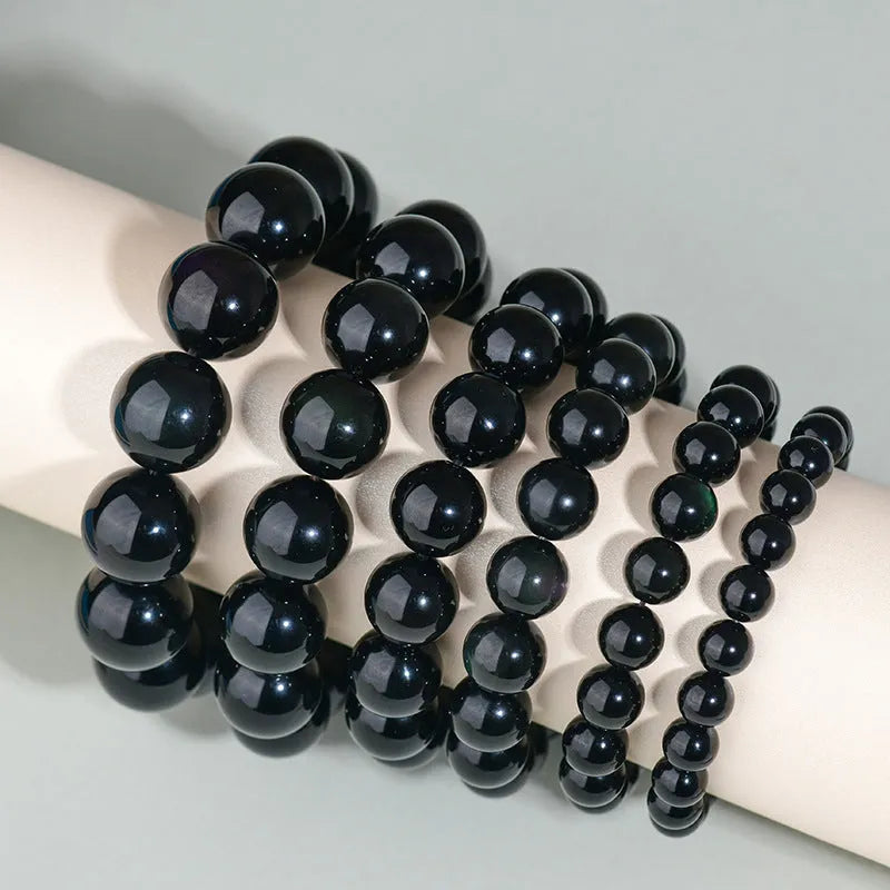 Hand-woven obsidian couple bracelets showing six crystal colour variations with round beads in ethnic style design
