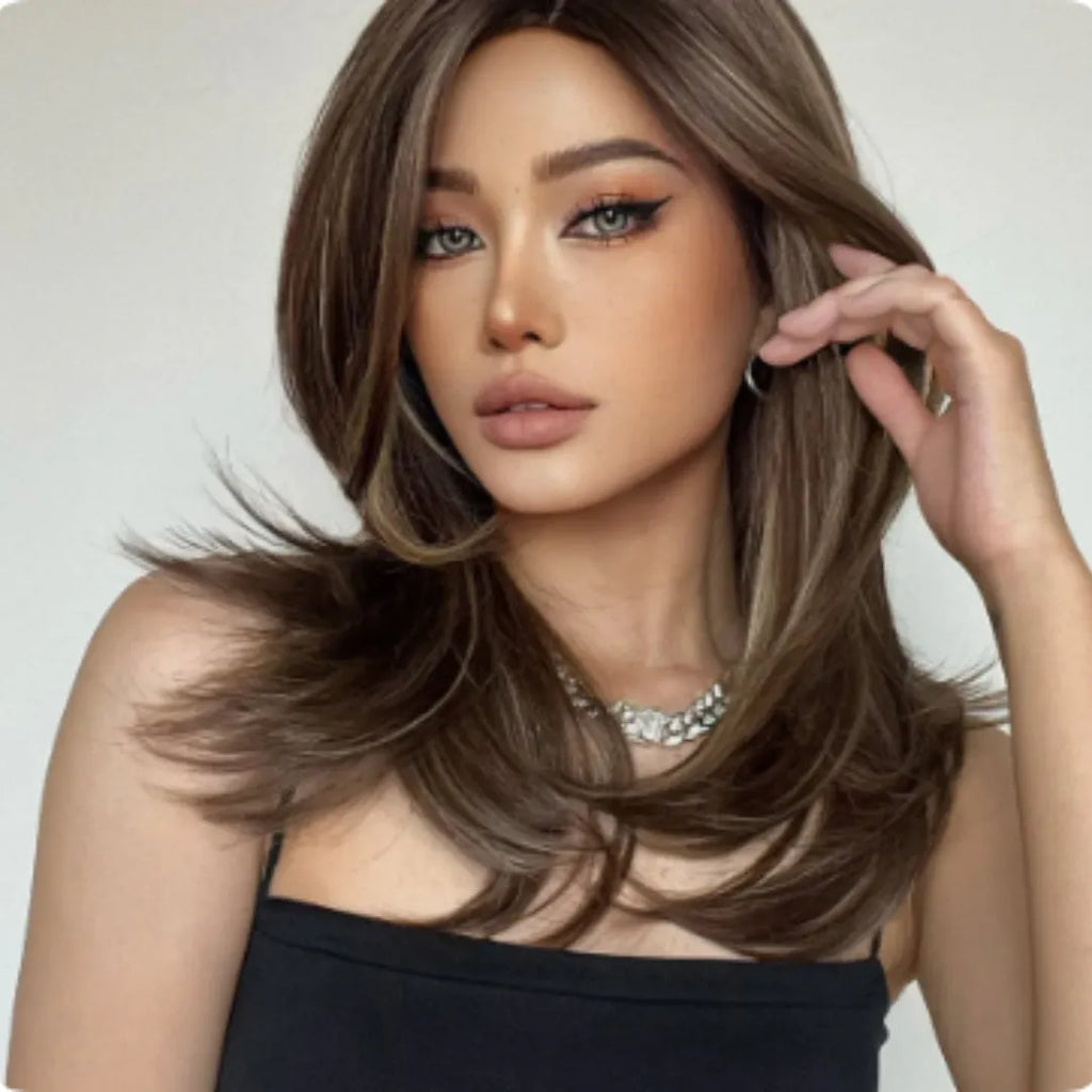 Mid-length curly full-head wig in a platinum gradient colour on a mannequin head.