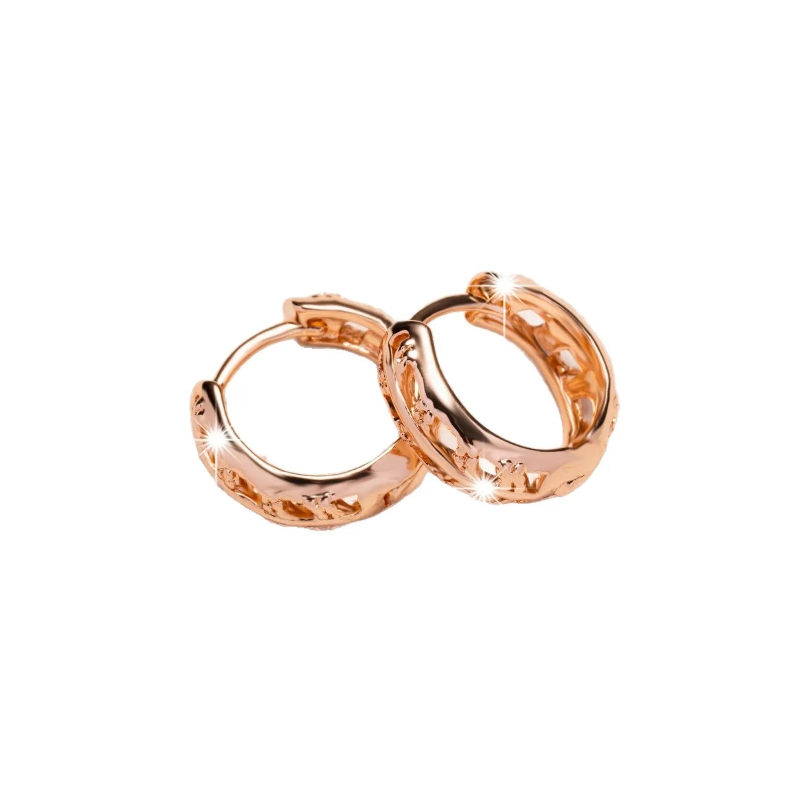 Rose gold coloured copper earrings with a hollowed leaf design and small heart detail.