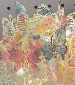 Handmade butterfly-shaped night lamp with glass shade on a raw wood base.