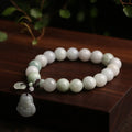 Jade hanging charm bracelet with geometric design and Buddhist symbolic pendant