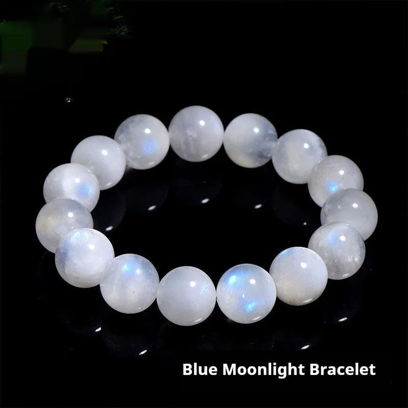 Natural blue moonlight round bead bracelet made from polished moonstone stones on a wrist.