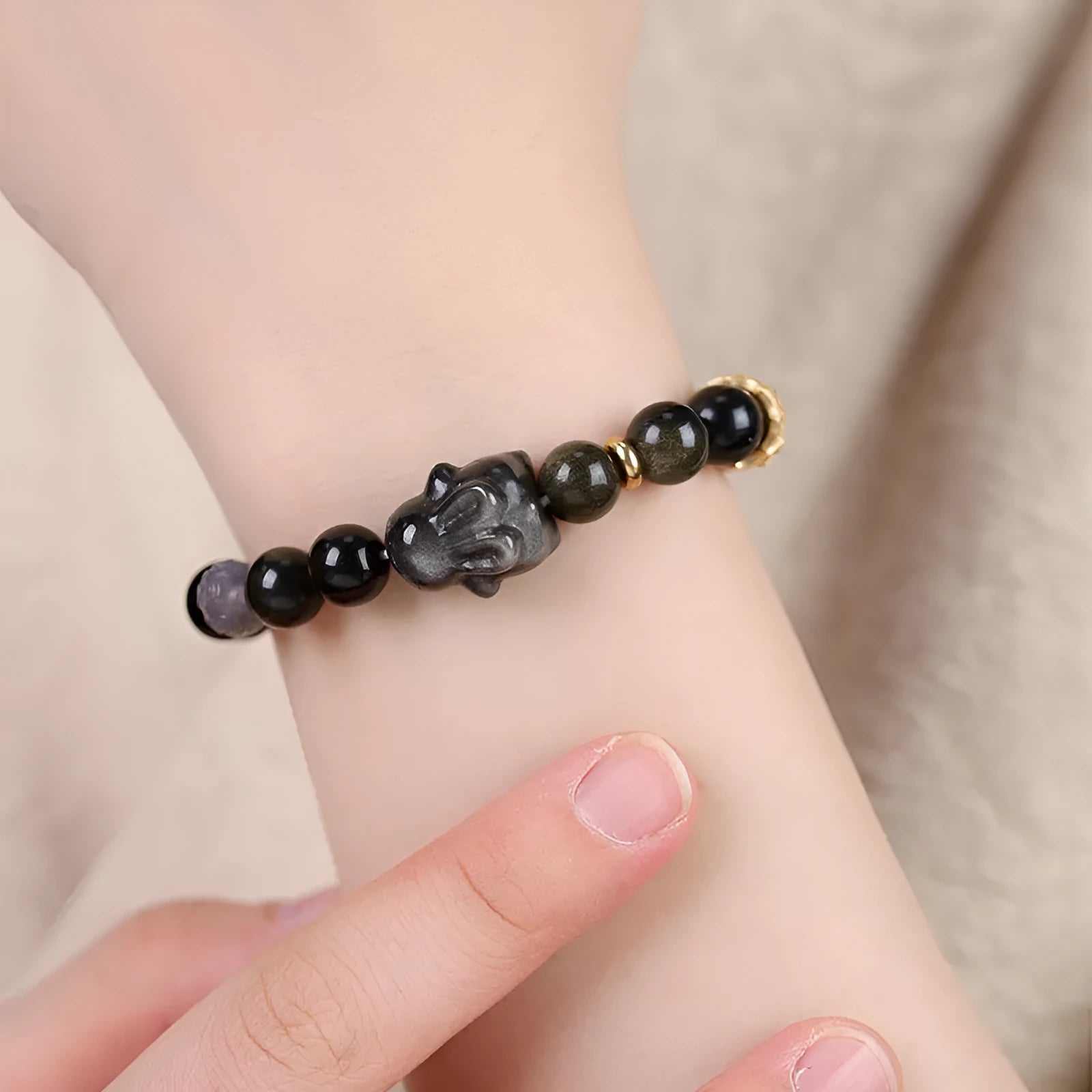 Handmade lying rabbit charm bracelet in Jin Yaoshi or Silver Yaoshi with 8mm or 10mm beads and grey agate accents.
