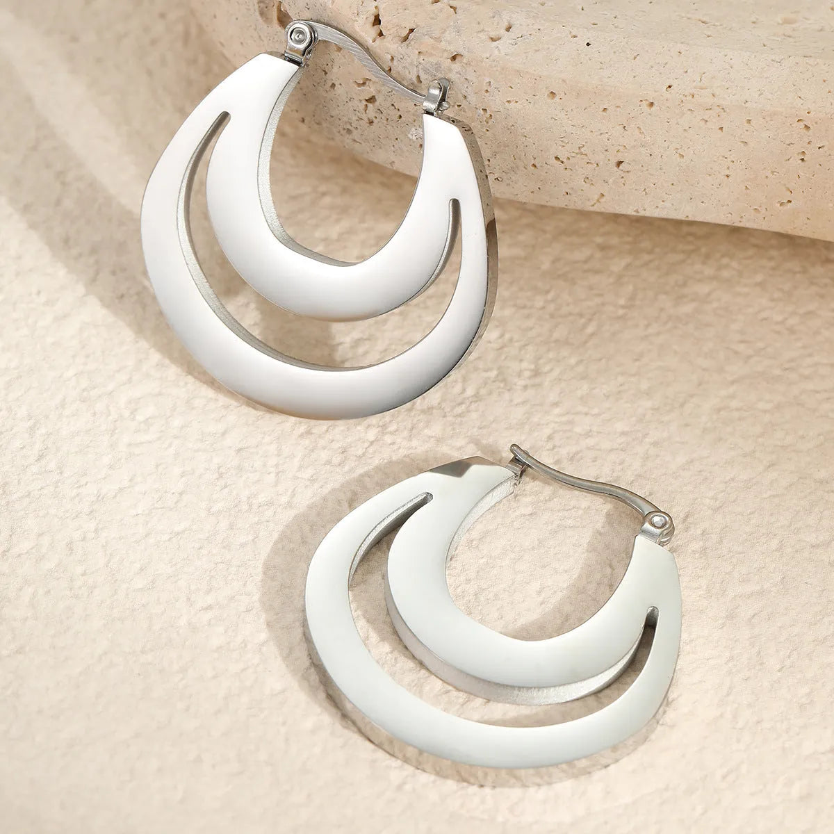 Geometric gold plated French earrings with round ring elements on stainless steel