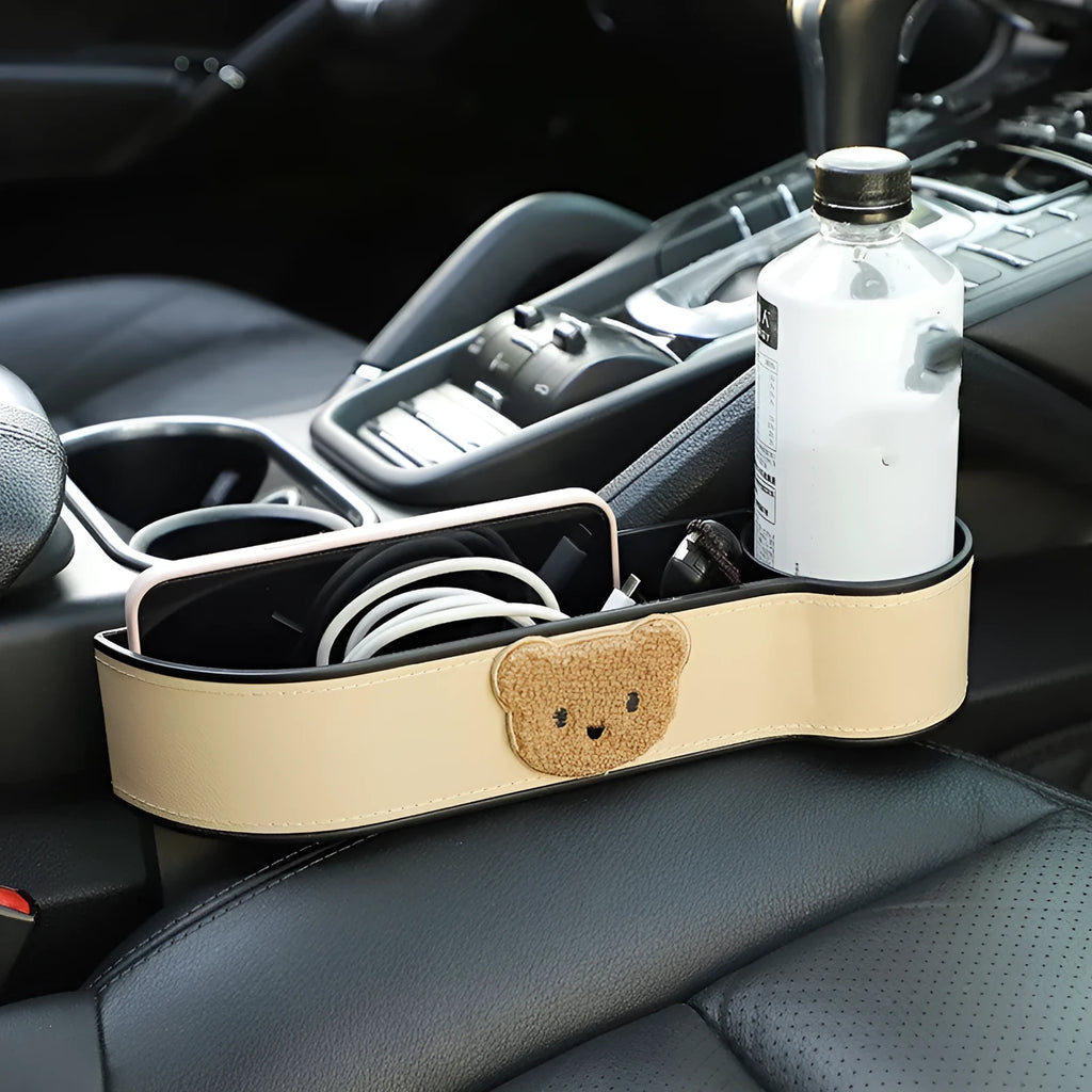 Leather car seat gap storage box with a cartoon bear design hanging next to a car seat.