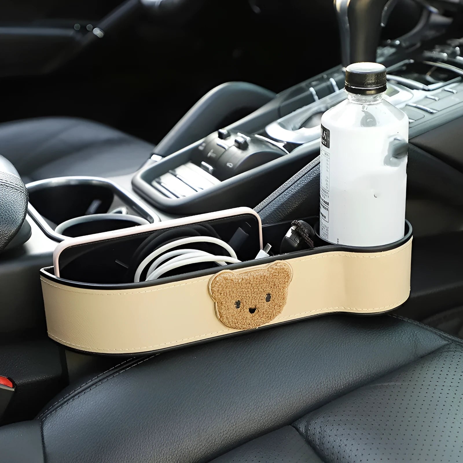 Leather car seat gap storage box with a cartoon bear design hanging next to a car seat.