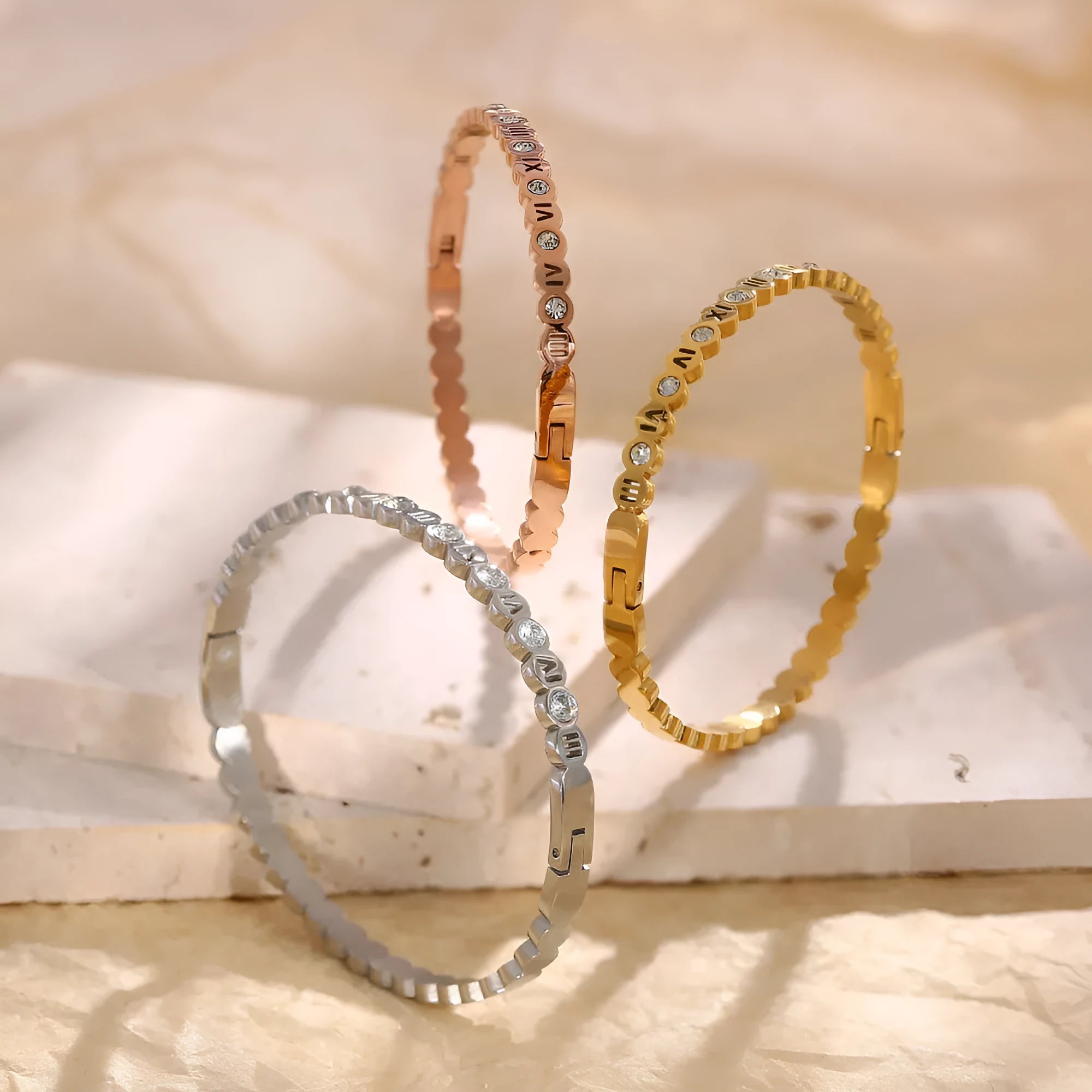 Adjustable titanium steel fashion bracelet with number charms in a choice of gold, rose gold, or steel colour.