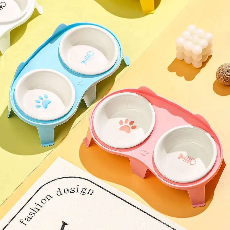 Blue ceramic cat food and water bowls on a white elevated ABS stand with a hook.