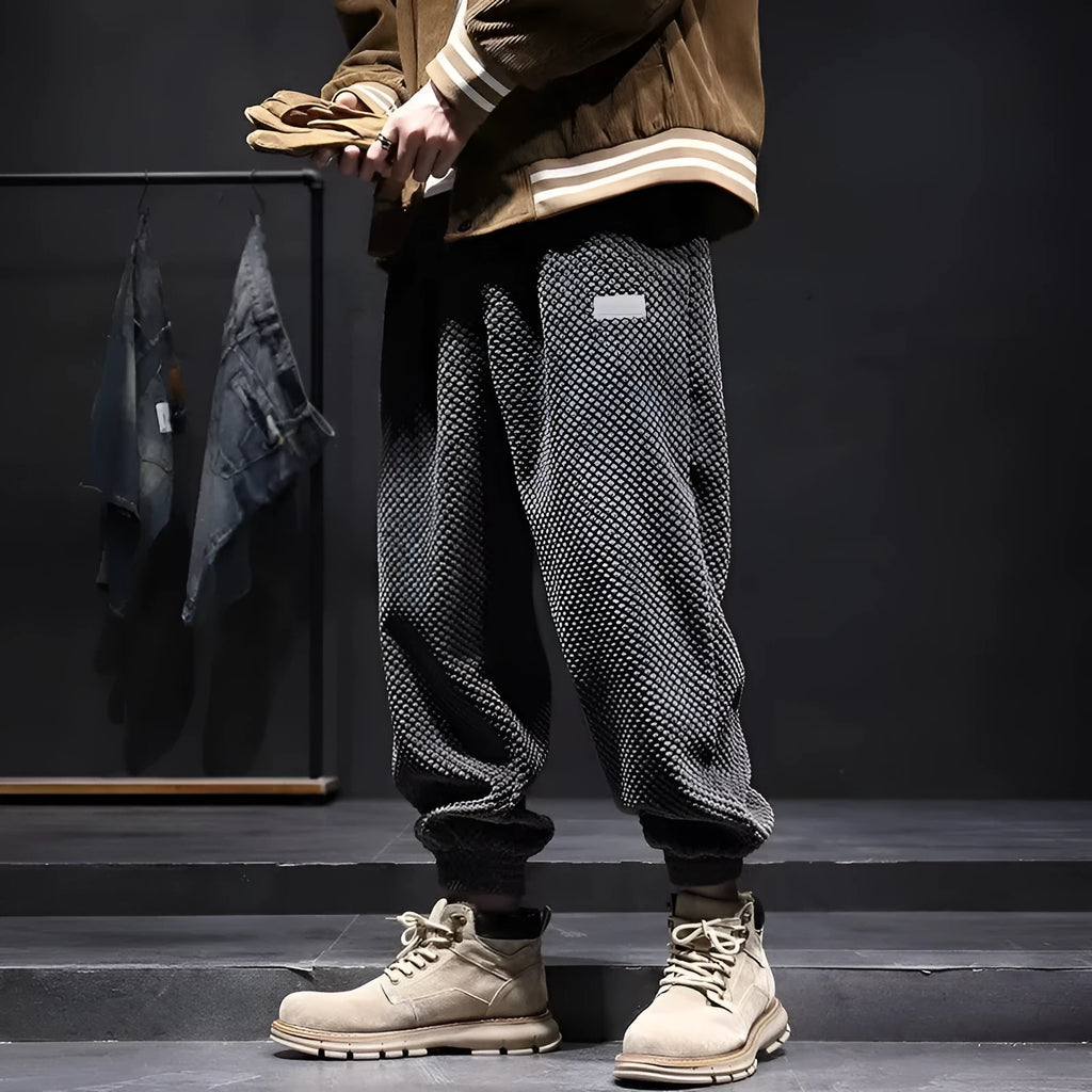 Men's grey straight-leg sweatpants with an adjustable ankle strap, laid flat.