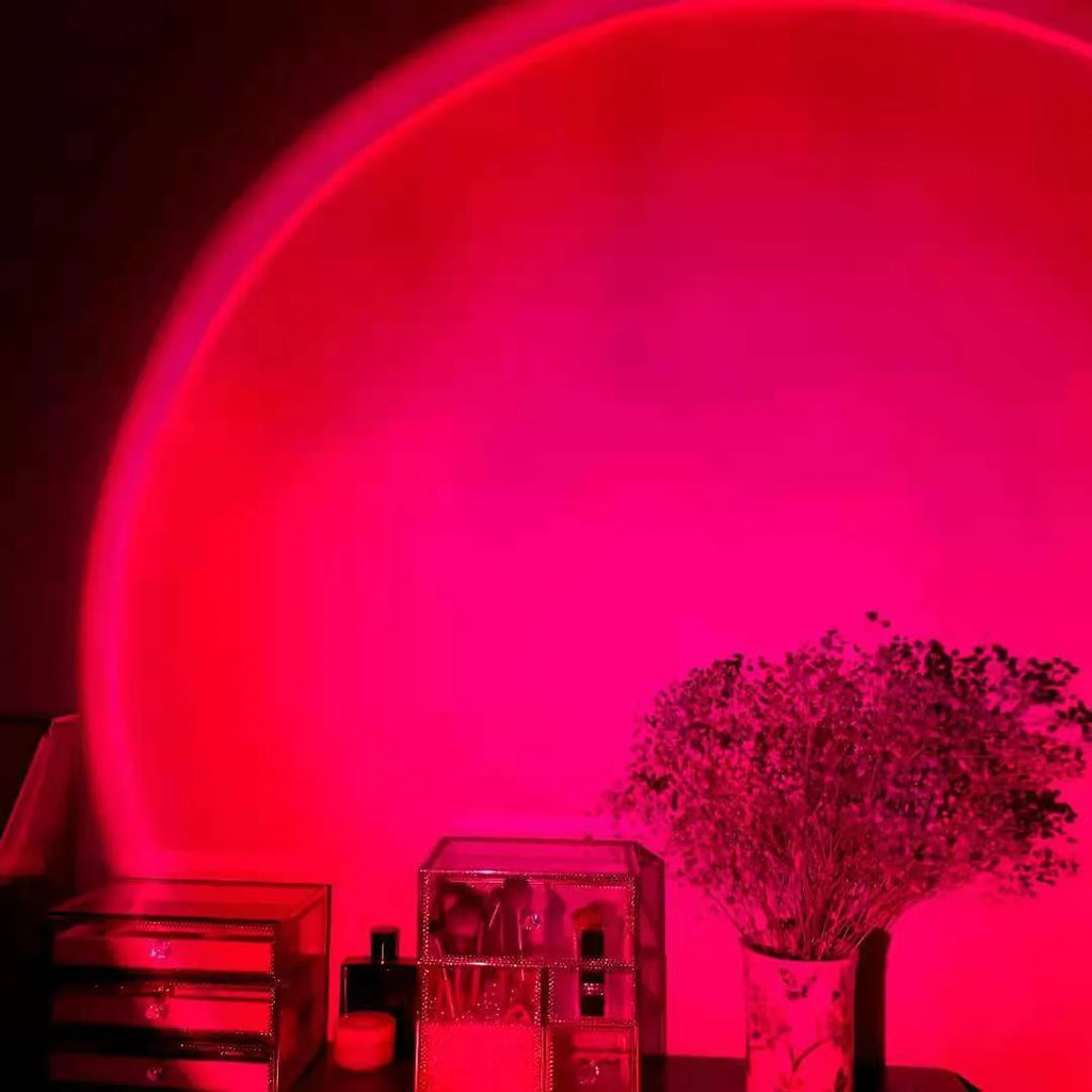 Rechargeable sunset red and rainbow projection lamp with USB cable and push-button switch.