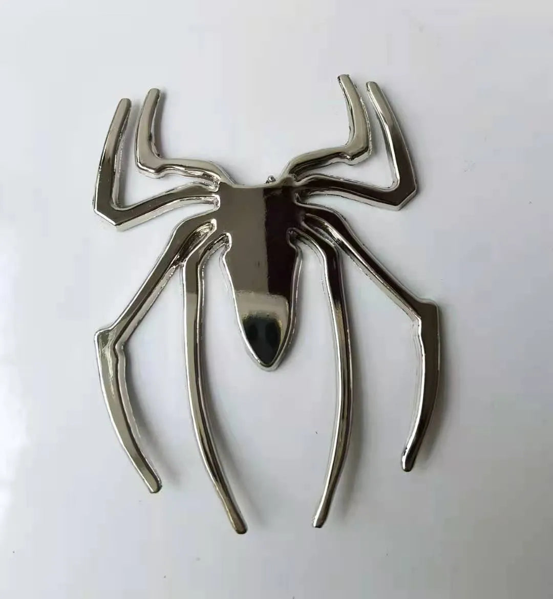 Gold 3D metal spider bumper sticker on a car bumper