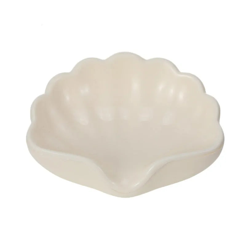 White and pink plastic shell-shaped soap dish for bathroom use