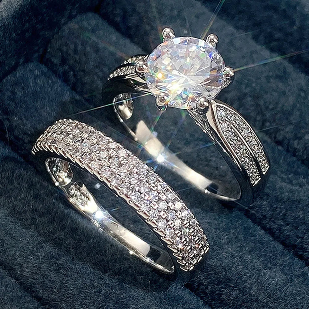 White gold colour geometric alloy wedding ring on a finger, showing its simple round band design.