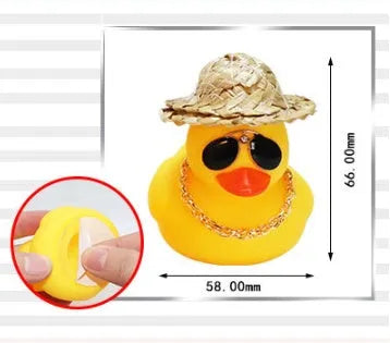 Cartoon yellow duck wearing a straw hat car dashboard ornament on a matte yellow base.