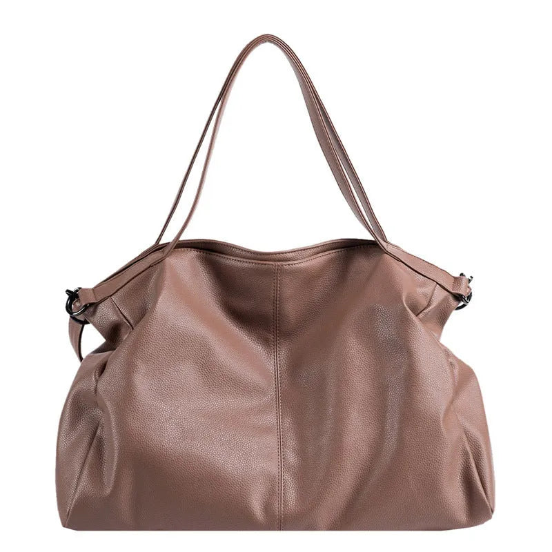 Large soft black PU leather messenger tote bag with a shoulder strap, showing zipper and phone pocket.