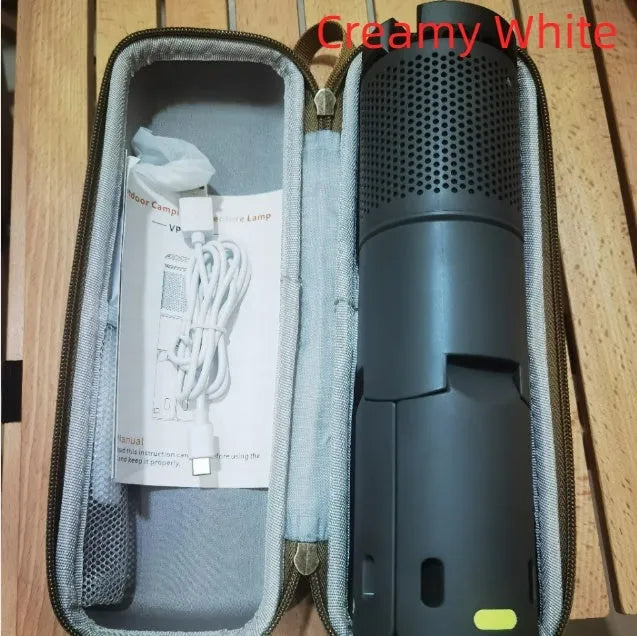 Portable creamy white and dark grey LED camping lantern with a button switch on a table.