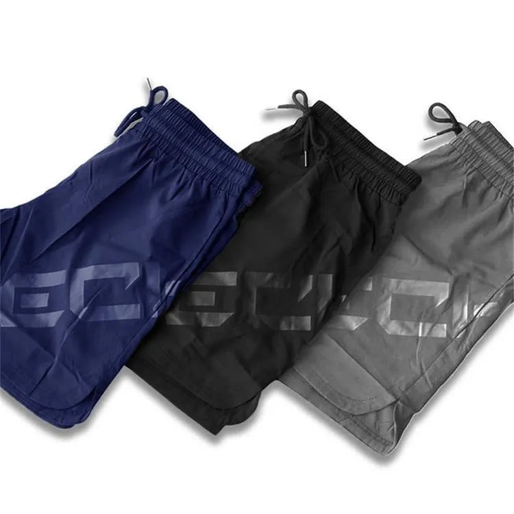 Men's black elastic training shorts with a mid-waist and knee-length cut for summer sports.