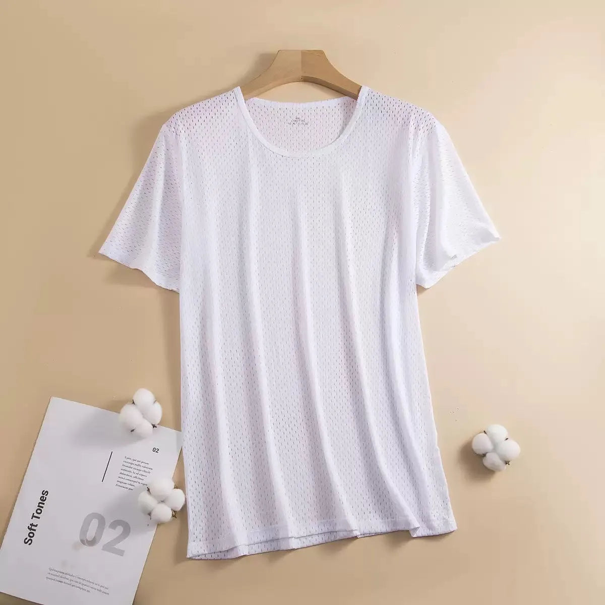 Man wearing a loose-fitting grey ice silk short sleeve crew neck T-shirt.