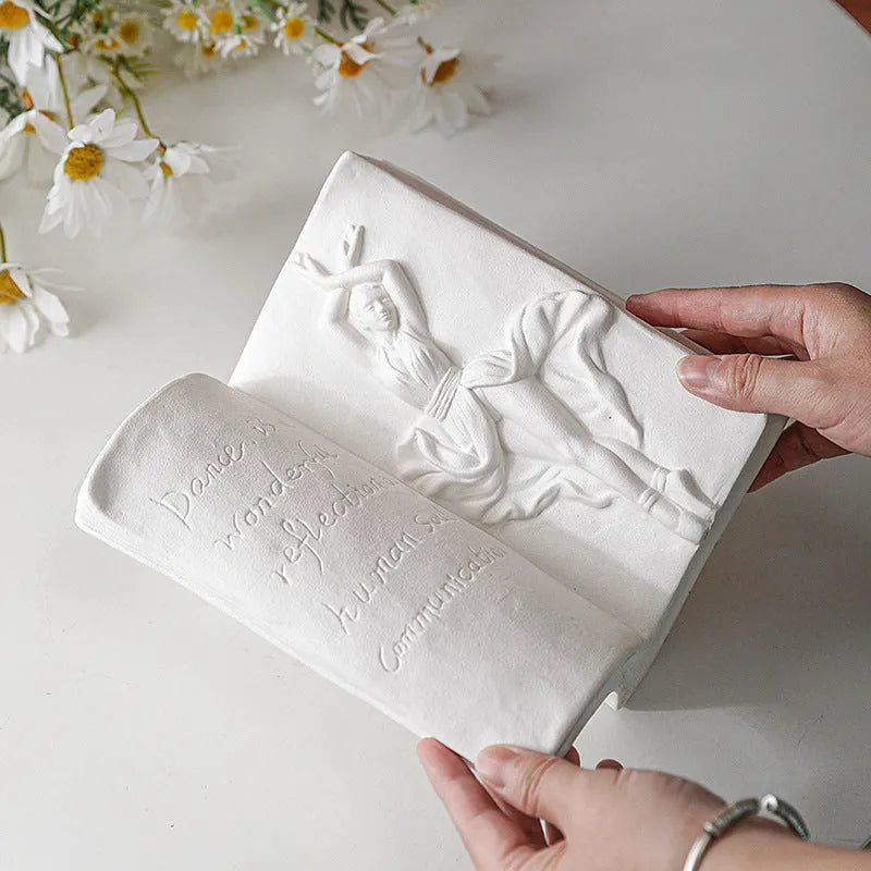 Ceramic decorative book stand in a modern simplicity style on a wooden desk.