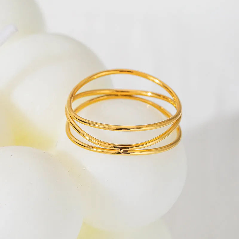 Gold titanium steel geometric ring with three-layer coil design shown from multiple angles