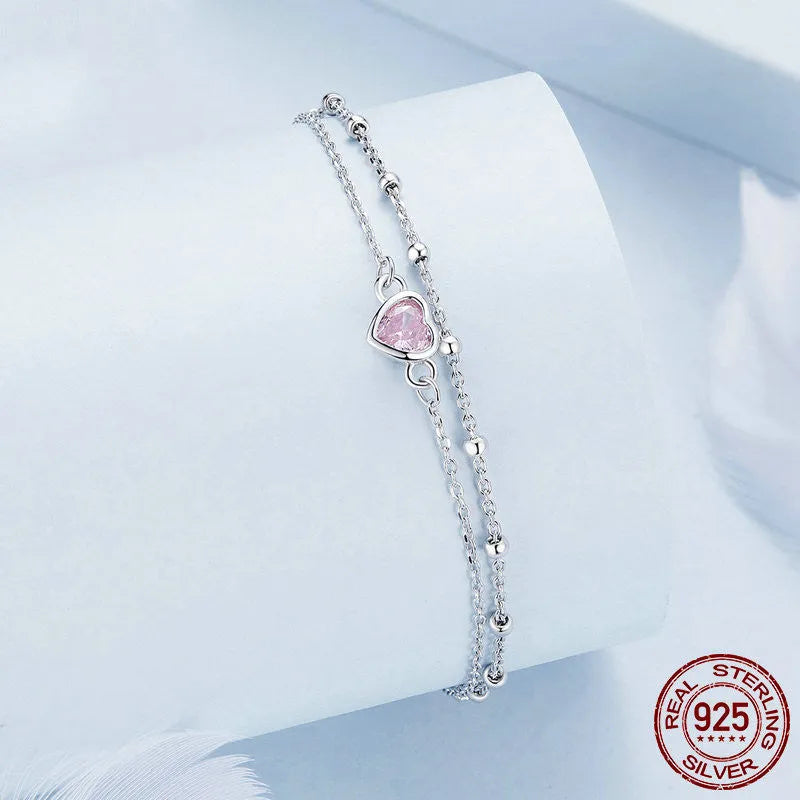 Sweet girlish style 925 sterling silver bracelet with a small heart-shaped charm on a chain.