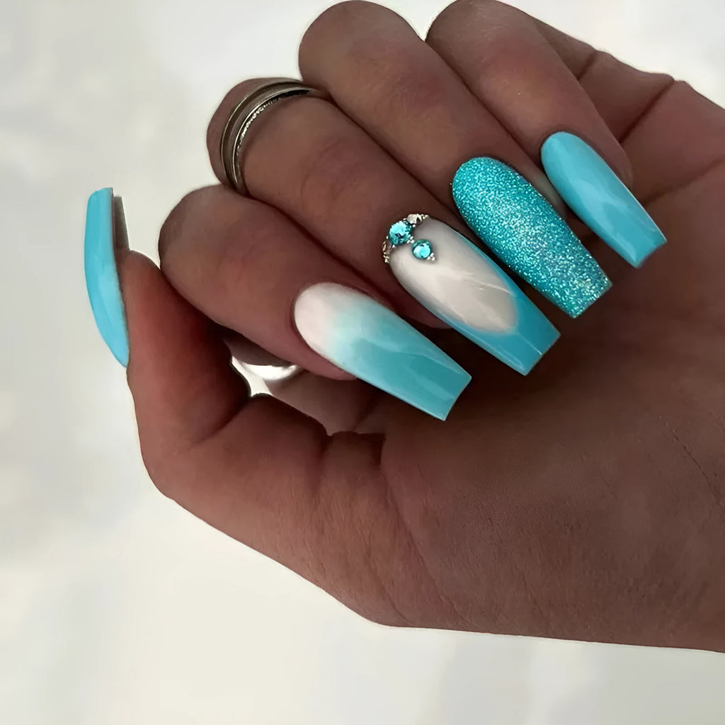 Long ballet artificial nails in smart blue diamond colour with glitter debris particles