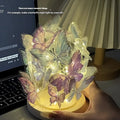 Handmade butterfly-shaped night lamp with glass shade on a raw wood base.
