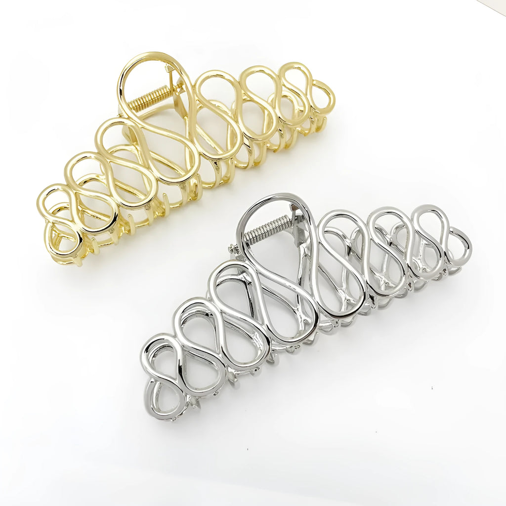 Large minimalist hair clip with tassel decoration in gold finish showing irregular shape design