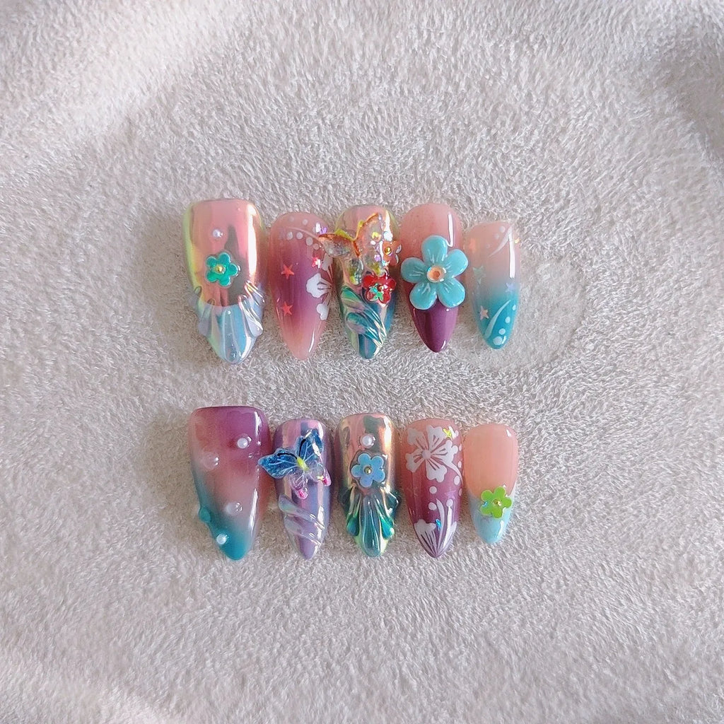 Handmade 3D nail art sculpture of embossed flowers and butterflies on an almond-shaped base.