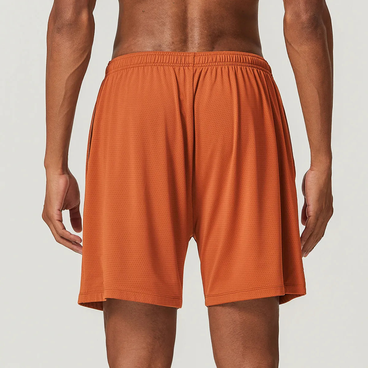 Men's quick-drying nylon running shorts in sky green, shown with mid-waist and short length design.