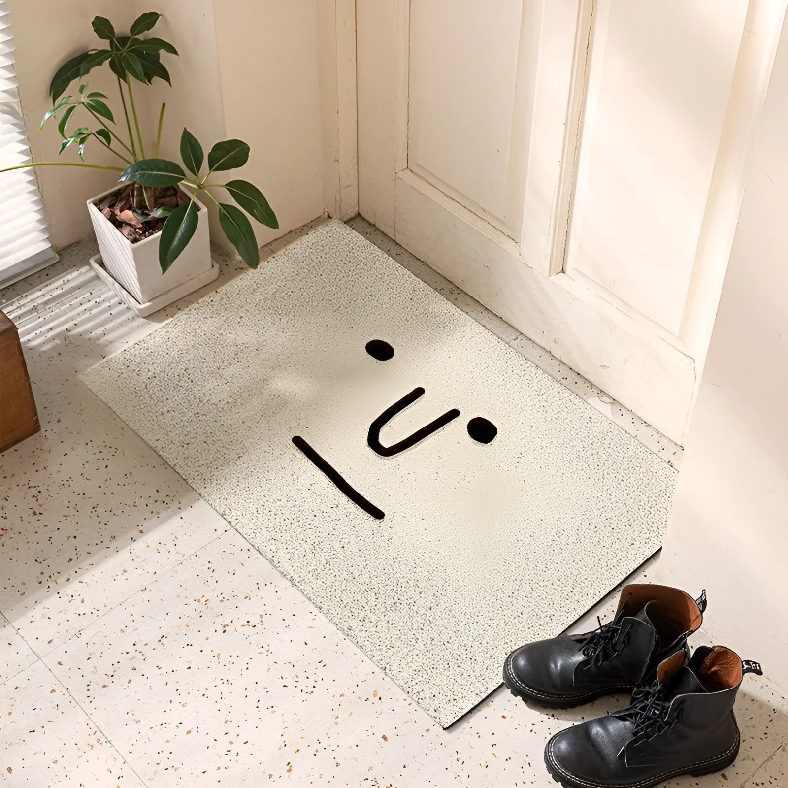 Square PVC floor mat with a geometric cartoon face pattern in Mr. Big Nose colour.