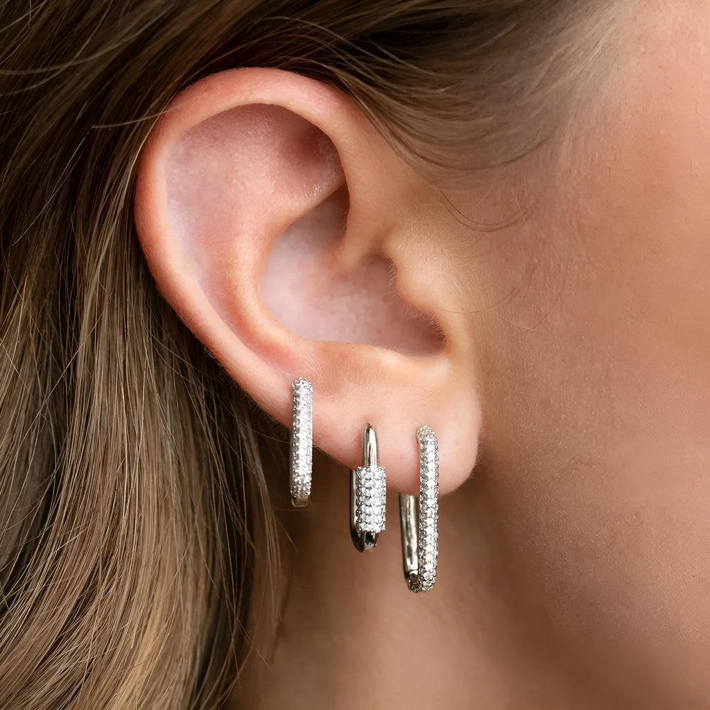 Three geometric square ear clips with inlaid zircon stones in gold and white gold colours