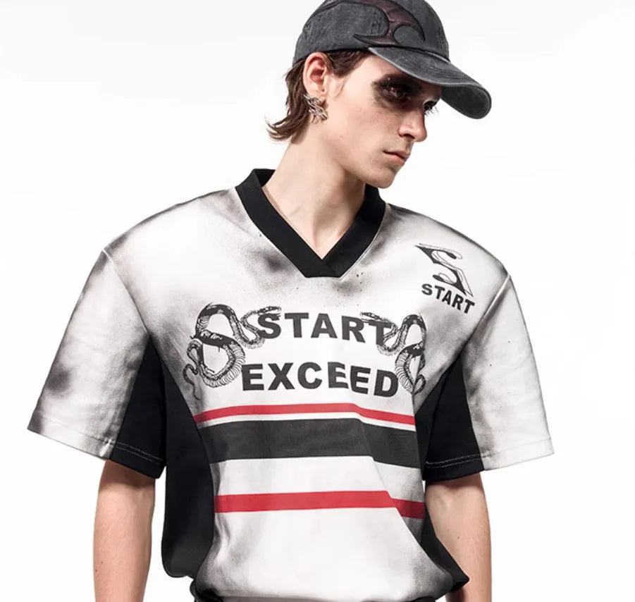 V-neck short sleeve top with padded shoulders featuring letter snake pattern print