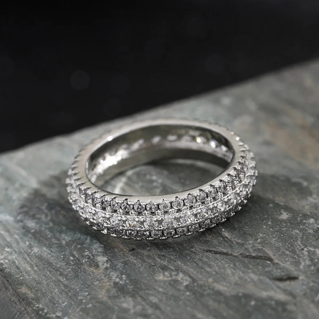 Geometric triangular unisex ring with a central zircon stone, shown in white gold, yellow gold, and white and black plating options.