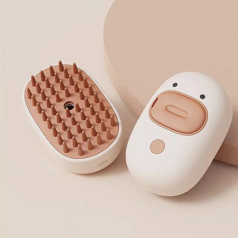 White rechargeable cat and dog steam brush with rubber comb teeth and water tank.