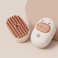 White rechargeable cat and dog steam brush with rubber comb teeth and water tank.