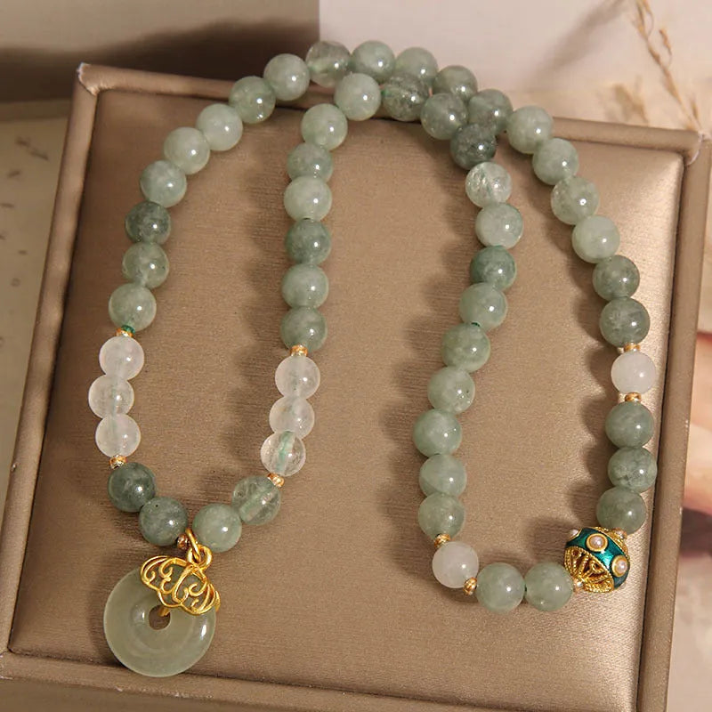 Women's double-layer aventurine jade bracelet in oil green with a safety buckle and rhinestone details.
