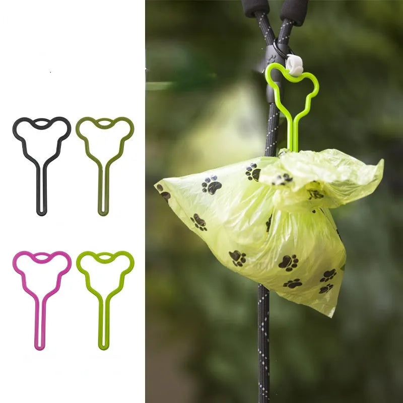A hands-free dog waste bag holder with a Velcro strap, attached to a dog leash.