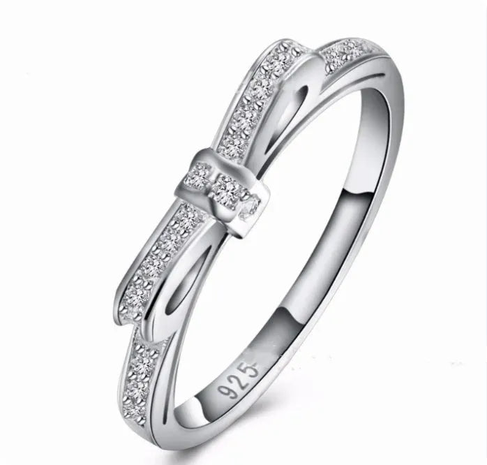 Silver bow ring with rhinestone crystals in couple style band design