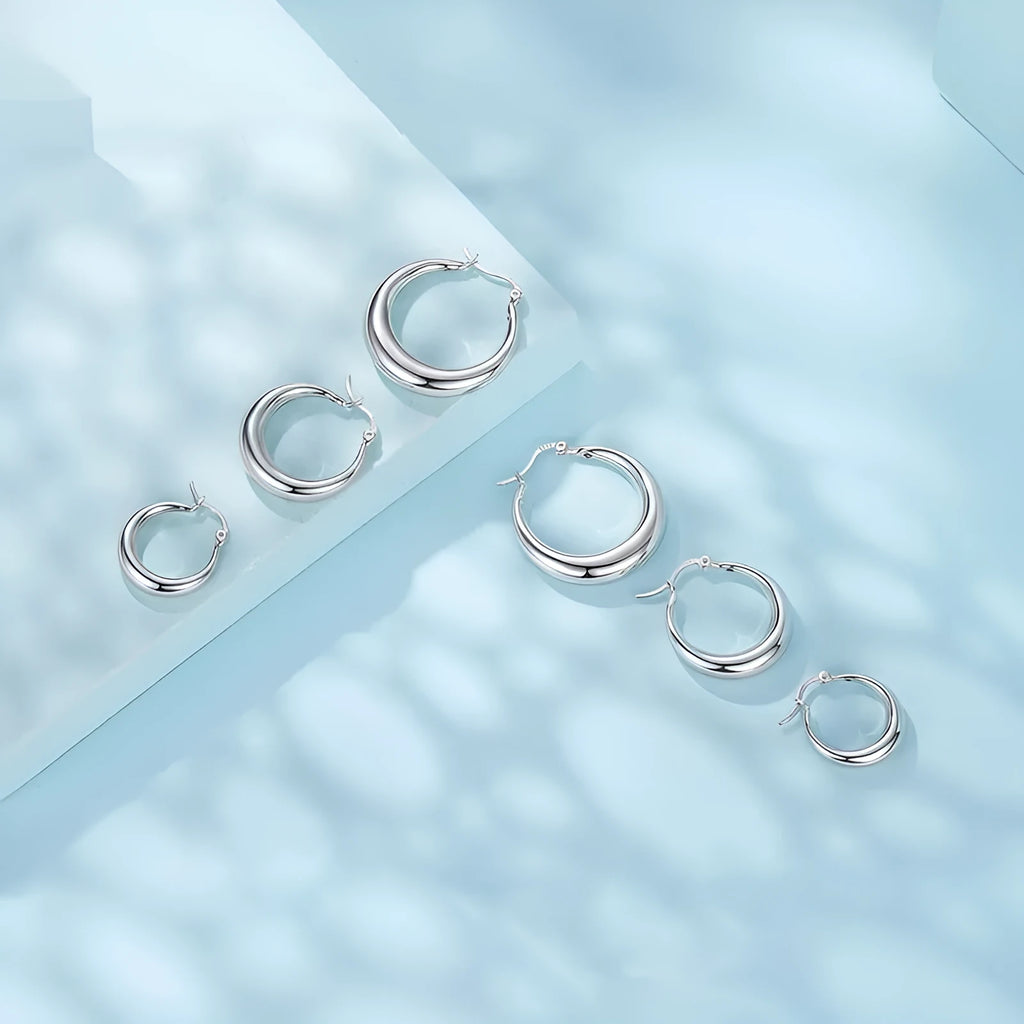 Copper geometric ring clip-on earrings with silver needle detail in three sizes.