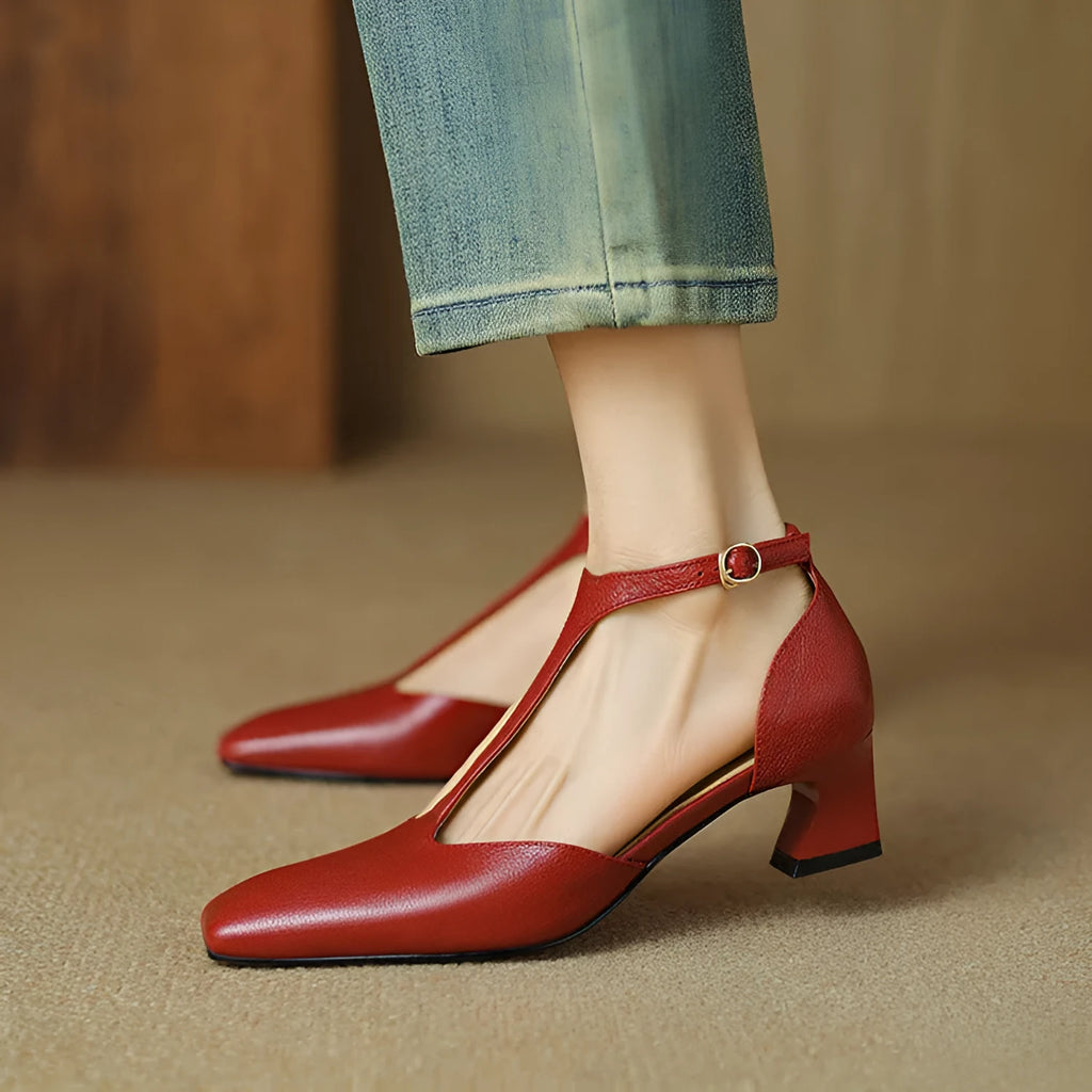 Wine red women's high heels with a square toe, chunky heel, buckle fastening, and visible stitching.