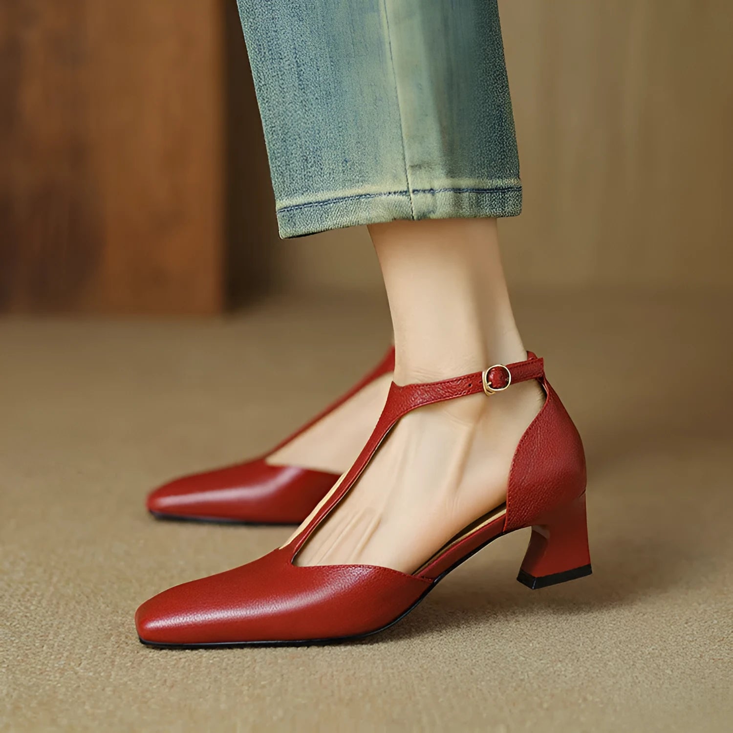Wine red women's high heels with a square toe, chunky heel, buckle fastening, and visible stitching.